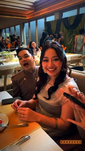 A couple smiling at their table