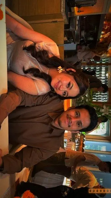 Two guests leaning their heads together